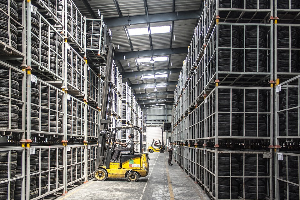 Warehouse interior with forklift and tire stacks